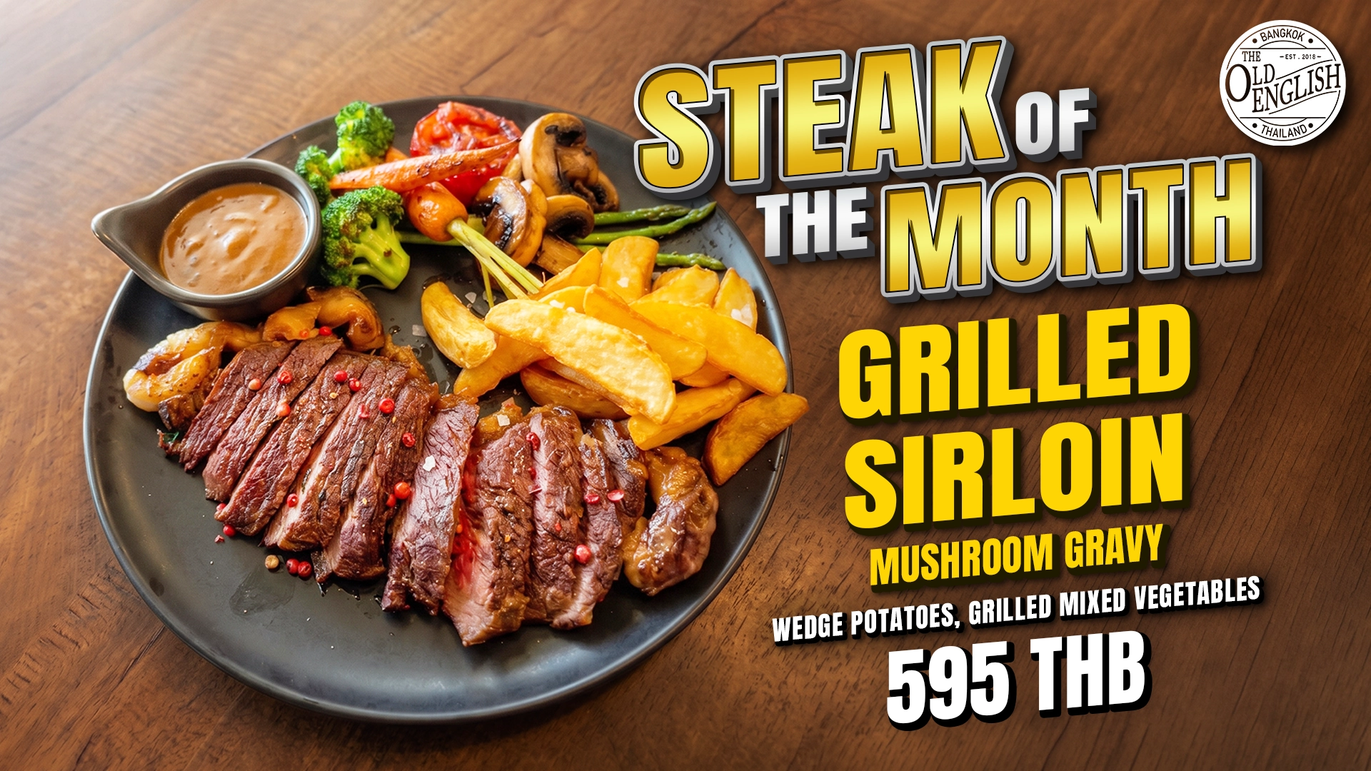 The Old English Bangkok's July Steak of the Month featuring a premium grilled sirloin, wedge potatoes, grilled mixed vegetables, and mushroom gravy for 595 THB